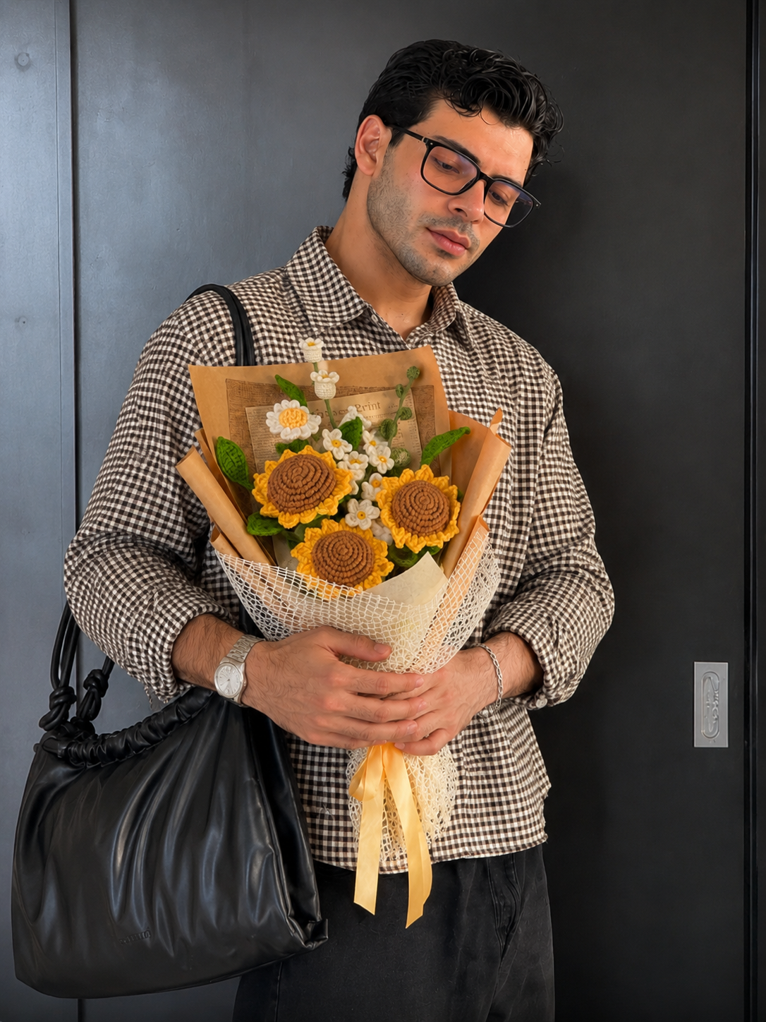 Customer holding a handmade crochet sunflower bouquet