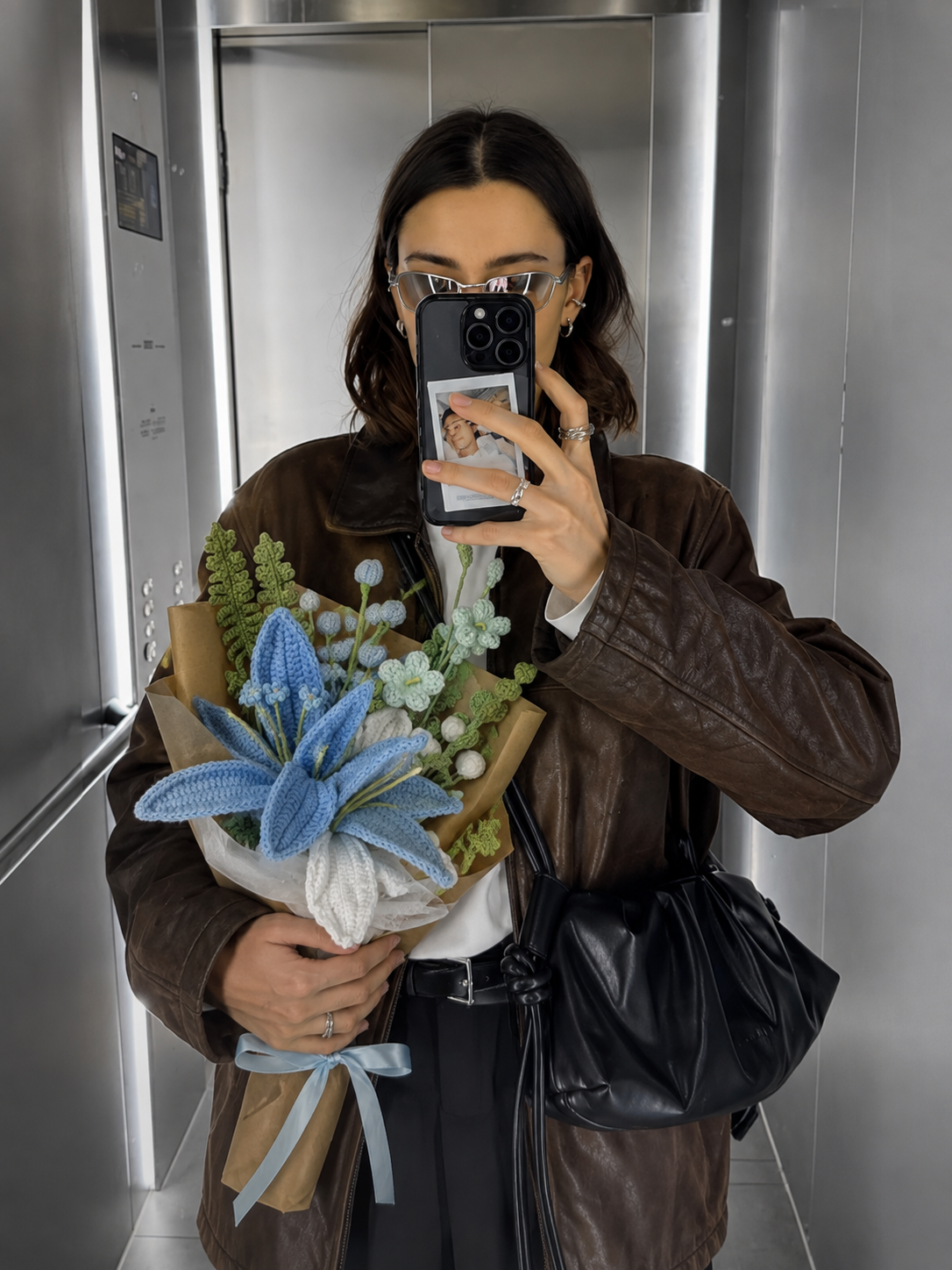 Customer mirror selfie with handmade crochet blue lily bouquet